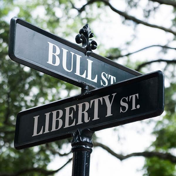 Street Sign black and white stacked street sign under trees