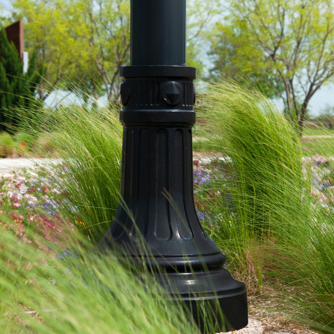 Decorative Die Cast Signpost Base In Public Streetscape. black die cast metal signpost base