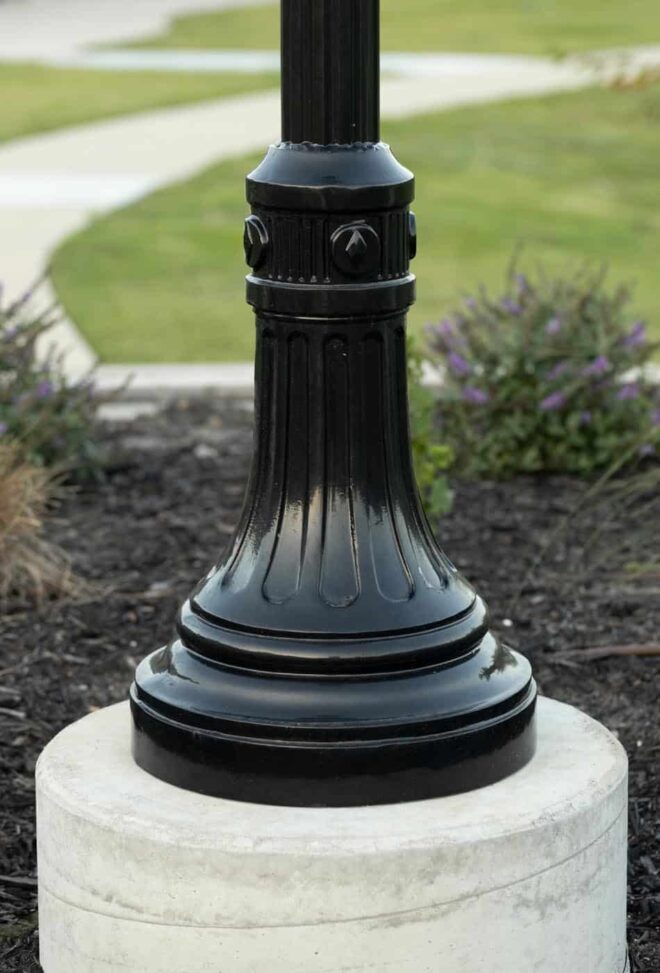 Close-up view of a fluted round pole and a two-piece decorative base.