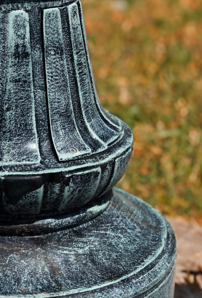 Extreme close-up of the decorative base of a lamp post.