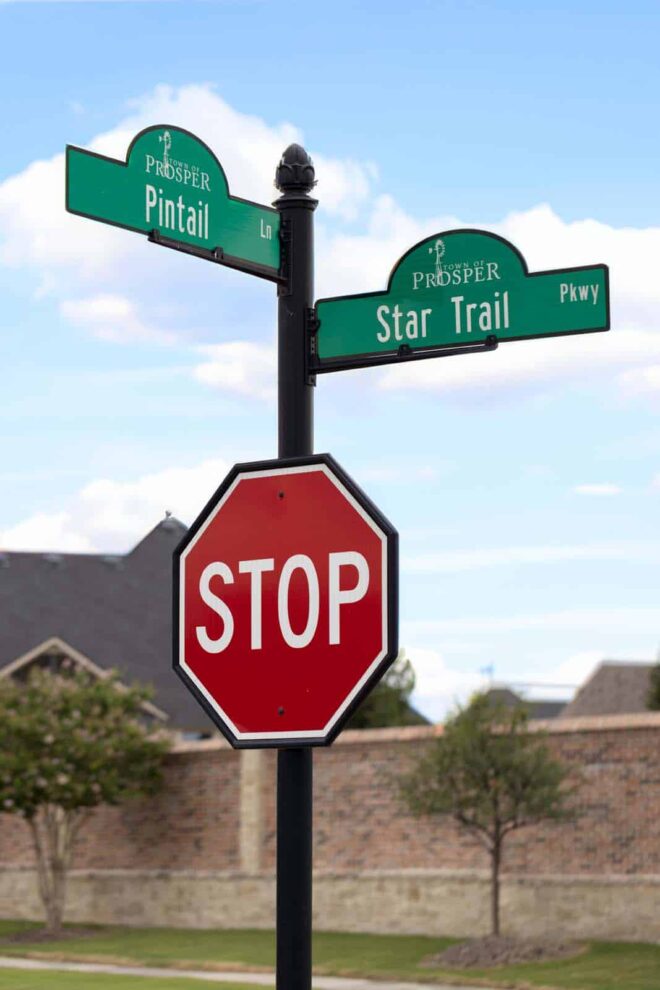 Close-up of a residential street sign/stop sign combo.