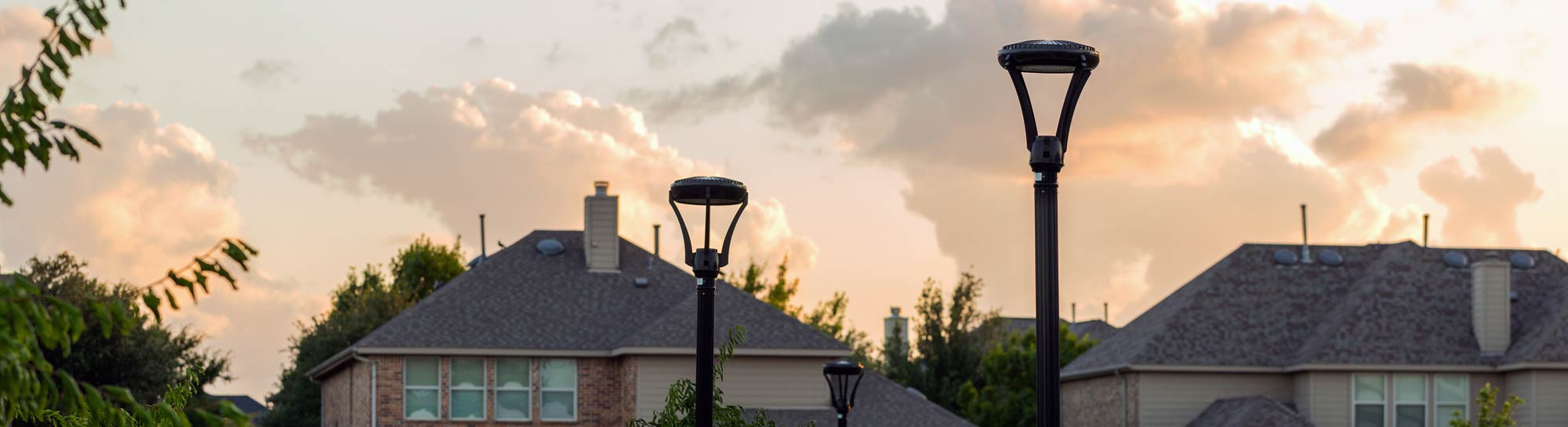 Two LED streetlights at sunset